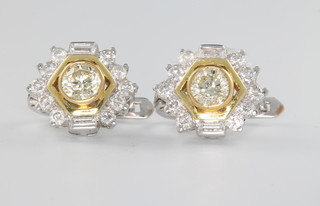 A pair of 18ct white gold ear clips, the centre yellow diamonds approx 0.7ct surrounded by brilliant and baguette cut diamonds approx 0.6ct 