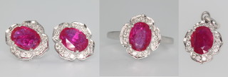 A suite of 9ct white gold ruby and diamond set jewellery comprising ear studs, pendant and ring size P 
