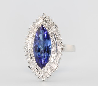 A 14ct white gold marquise cut tanzanite and diamond ring, the centre stone approx. 5.55ct surrounded by tapered baguette and brilliant cut diamonds approx. 1.05ct size Q 1/2