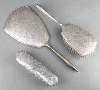 A silver 3 piece brush set with chased scroll and leaf decoration Birmingham 1970