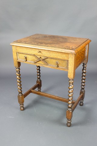 An oak canteen with lift top containing a set of plated cutlery for 12 with fitted drawer raised on barley twist supports 