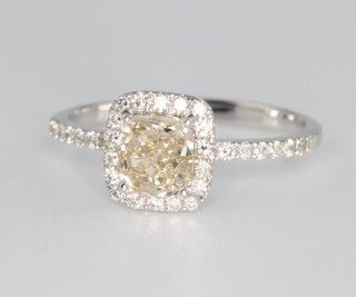 An 18ct white gold diamond ring the centre yellow stone approx 1.03ct surrounded by brilliant cut diamonds size N 
