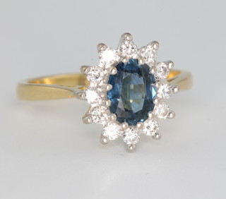 An 18ct yellow gold oval sapphire and diamond cluster ring, the centre stone surrounded by 12 brilliant cut diamonds size L  

