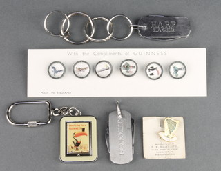 A set of 6 Guinness buttons, key ring and 2 pen knives together with a badge