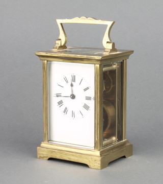 A French 19th/20th Century carriage timepiece with enamelled dial and Roman numerals contained in a gilt metal case 4"h x 3"w x  2 1/2" complete with wooden carrying case