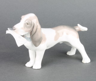 A Lladro figure of a basset hound with a newspaper in his mouth 7" 