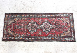 A red ground Mahal runner with  a 3 row border 81" x 33", in wear