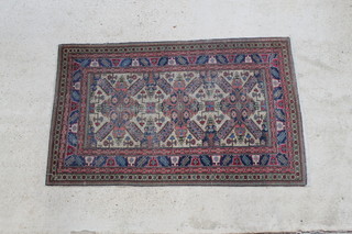 A blue and white Caucasian rug with 3 stylised medallions to the centre within a multi row border 73" x 46" 