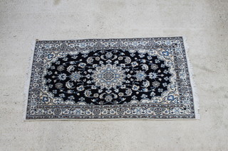 A blue and white ground Persian Nain rug with central medallion 83" x 45" 