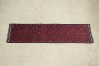 A red and blue Meshwani runner decorated with 23 stylised diamonds 102 x 25" 