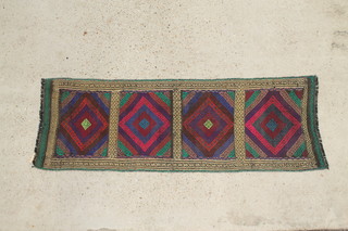 A multi coloured Kilim runner formed of 4 panels decorated stylised diamond medallions 65" x 22 1/2" 