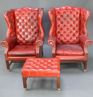 A pair of Georgian style winged armchairs upholstered in red leather with H framed stretcher together with a matching footstool 