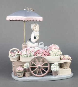 A Lladro group Flowers of the Season of a flower seller with barrow of flowers beneath a parasol 1454 12" 
