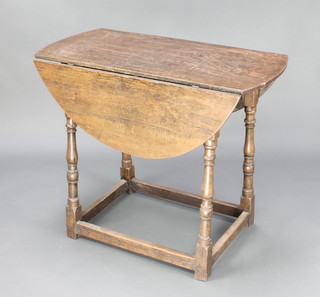 A 17th Century style oak oval drop flap dining/tea table, raised on turned and block supports with box framed stretcher 30"h x 36"w x 17 1/2" x 41" when extended 