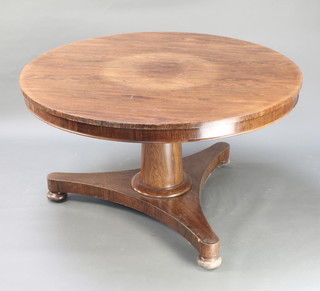 A Victorian circular rosewood snap top breakfast table raised on a turned column with triform base and bun feet 28"h x 50"diam. 