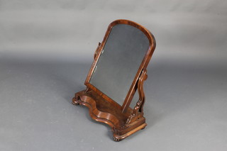 A Victorian arched plate dressing table mirror contained in a mahogany swing frame, the base of serpentine outline 32"h x 25"w x 12"d 