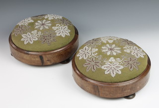 A pair of Victorian circular walnut footstools upholstered in green material with bead work decoration and raised on 4 turned feet 4" x 11" diam 