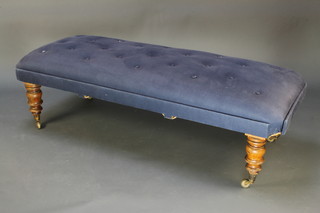 A Victorian style rectangular stool/window seat upholstered in blue buttoned material raised on turned supports 16"h x 57"w x 23"d