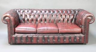 A 3 seat Chesterfield upholstered in red leather 28"h x 74"w x 33"d 
