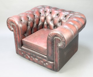 A Chesterfield armchair upholstered in red buttoned leather