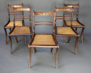 A set of 5 Regency rosewood and inlaid brass bar back dining chairs with woven rush seats, raised on sabre supports  
