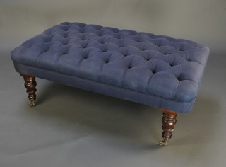 A Victorian style rectangular window seat upholstered in blue material and raised on turned supports with chrome caps and casters 16"h x 49 1/2"w x 28"d 
