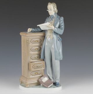 A Lladro figure of a gentleman standing beside a 5 drawer chest no.5213 13 1/2" 