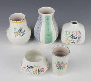 A Poole Pottery tapered vase decorated with a bird amongst flowers 4", do. squat vase 4", cylindrical vase decorated with flowers 4", a baluster vase decorated with flowers 5" and a baluster geometric vase 6" 