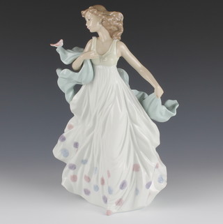 A Lladro figure of a lady with a bird on her shawl 5193 12 1/2" 