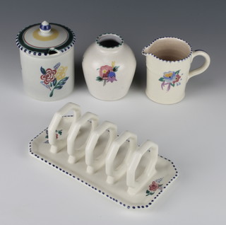 A Poole Pottery 5 bar toast rack decorated with flowers 7 1/2", do. vase 3", jug 3", preserve pot and cover 4" 