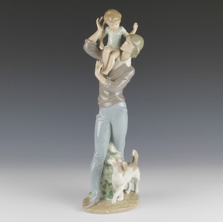 A Lladro group of a man holding a boy on his shoulders with a dog at his feet 5751 13 1/2" 