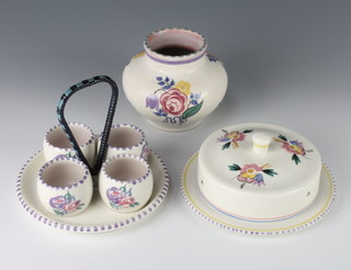 A Poole Carter Stabler Pottery egg cup stand and egg cups decorated with flowers 6", do. baluster vase 4" and a butter dish and cover 5" 