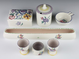 Two Poole Pottery egg cups decorated with flowers, do. preserve pot, salt, ashtray, box and cover and posy trough