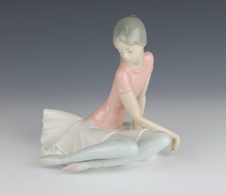 A Lladro figure of a seated ballerina 7" 