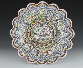 A 20th Century Portuguese polychrome fluted dish decorated with animals, birds and flowers 13 1/2" 