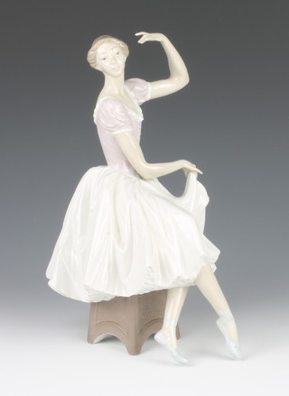 A Lladro figure of a seated ballerina 13" 