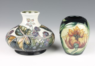 A contemporary Moorcroft square baluster vase decorated with flowers and berries 4" and do.  Moorcroft oviform vase decorated with stylised flowers 3 1/2" 