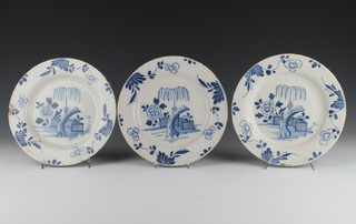 A set of 3 English 18th Century Delft plates decorated with a garden landscape enclosed by flowers 9 1/4" 
