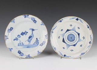 An 18th Century English Delft blue and white plate decorated with an exotic bird in a garden 9" together with a ditto shallow dish with geometric decoration 9" 