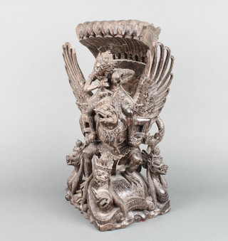An Eastern carved hardwood figure of a deity with mythical beast 16" x 9" x 8" 