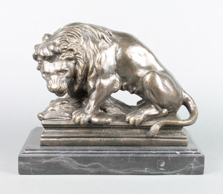 A bronze figure of a seated lion with wild boar raised on a black stepped marble base 10" x 11" x 6" 
