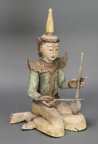 A Thai carved and painted figure of a seated musician 22" (1 finger f)