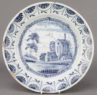An 18th Century English blue and white Delft ware shallow dish decorated with buildings within a stylised leaf border 12"  