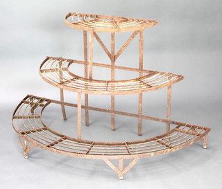 A Victorian wrought iron 3 tier graduated demi-lune plant stand 28"h x 47" at the widest point 
