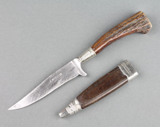 F Weglin, a German hunting knife with 3 1/2" blade and stag horn handle grip, contained in a leather and white metal mounted scabbard, blade marked F Weglin 
