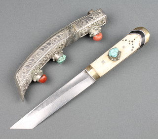 A Tibetan side knife with 5 1/2" blade, bone grip set hardstones and contained in a white metal and hardstone mounted scabbard 