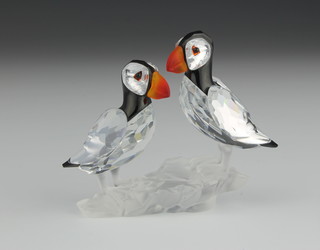 A Swarovski coloured Crystal group of 2 puffin 2 1/2" 