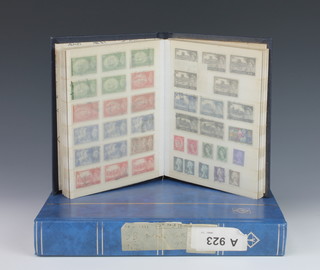 A blue stock book of Victorian and later GB stamps including penny reds together with  a blue stock book of GB stamps George V and later