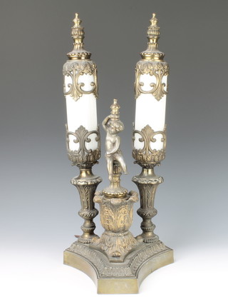 A Continental gilt metal twin light table lamp with pierced gilt metal mounts supported by a figure of a seated cherub on a triform base 21"h x 9 1/2" 