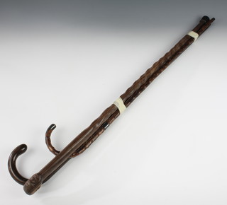 A rosewood walking cane with silver band, a holly walking cane with silver band and an African hardwood walking cane